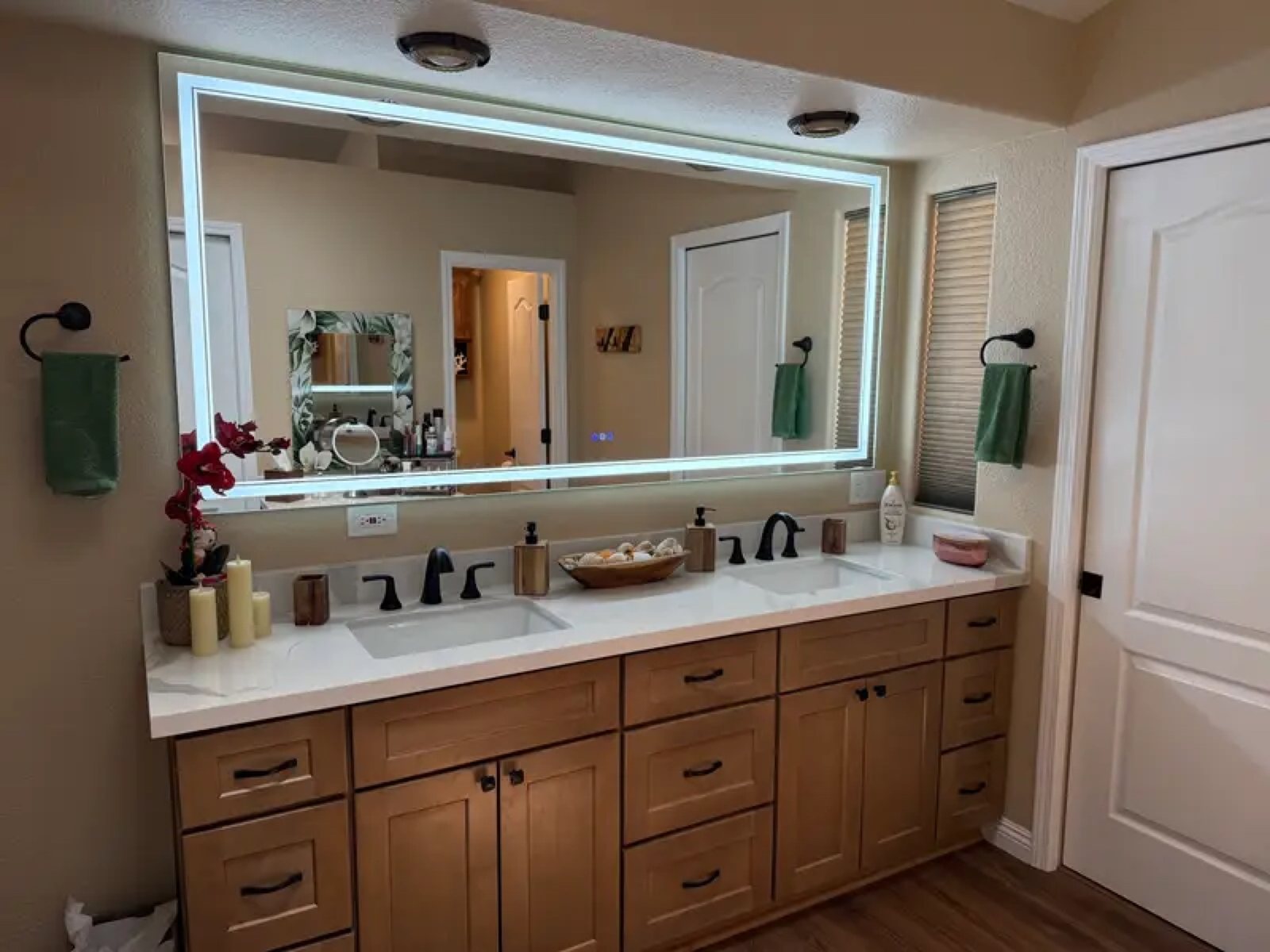 Bathroom with LED backlit mirror and double sink maple cabinet