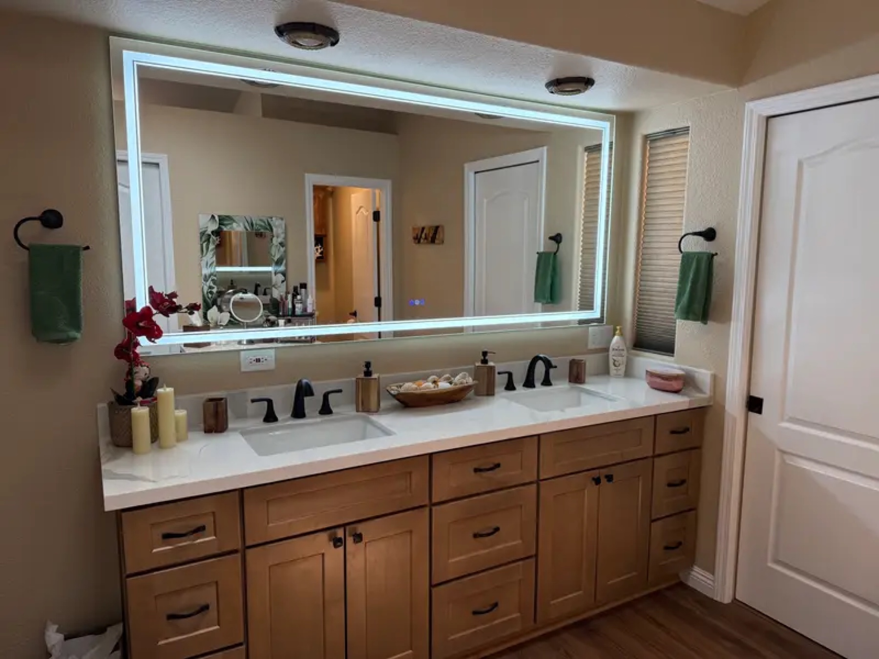 Bathroom with LED backlit mirror and double sink maple cabinet