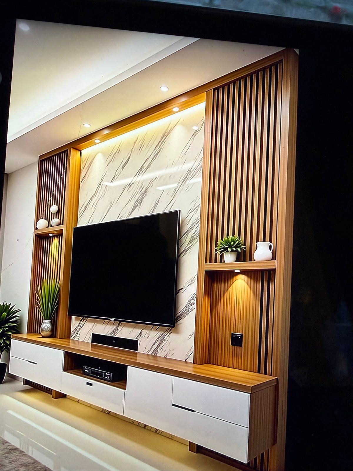 Custom entertainment wall with wood slat panels and marble LED backlit