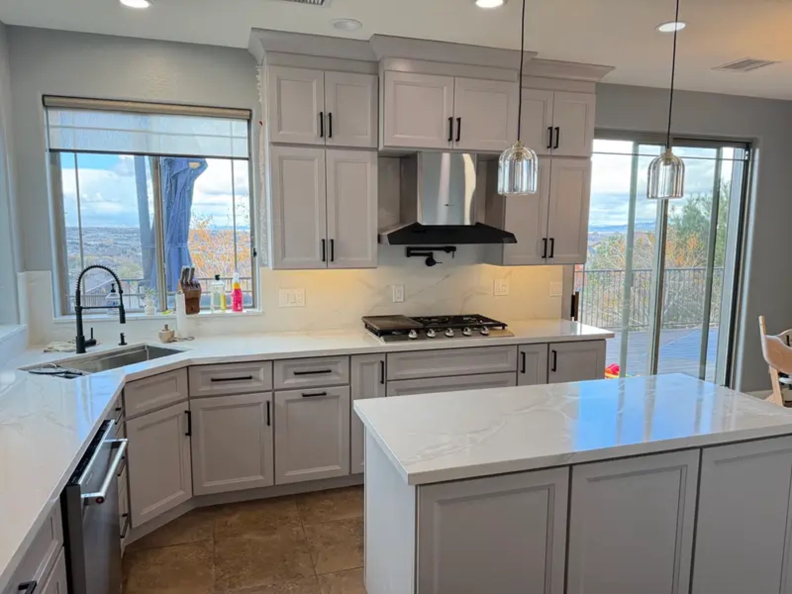 Gray kitchen with quartz island and mountain view windows