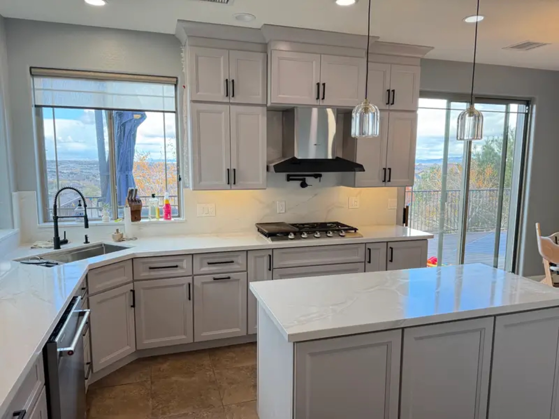 Gray kitchen with quartz island and mountain view windows